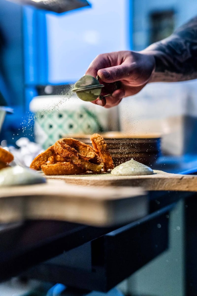 Seasoning food at Restaurant Soma